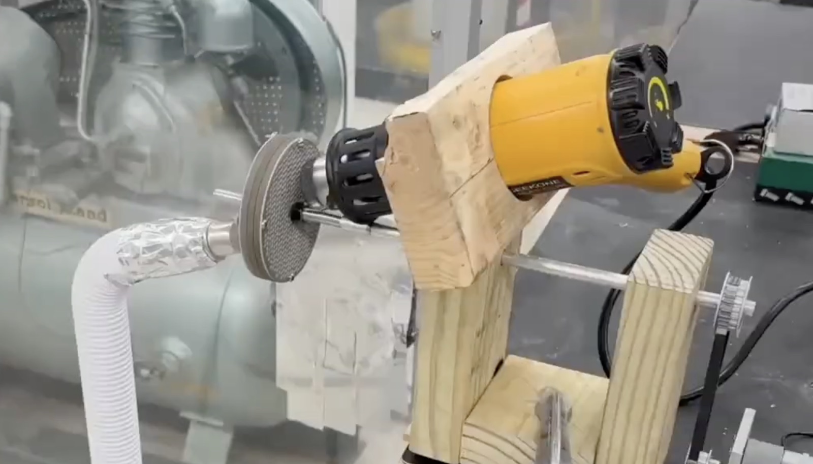 The machined desiccant wheel prototype mounted in its test rig, wired for the rotating proof-of-concept test.